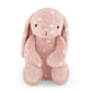 Pink plush bunny toy with white polka dots on a white background