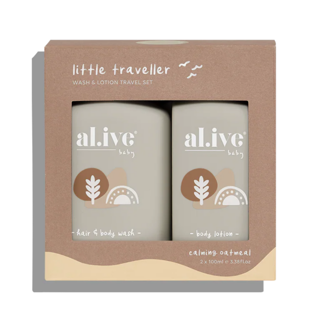 A boxed baby travel set from 'little traveller' containing two bottles of 'al ive' baby hair and body wash and body lotion in calming oatmeal scent, shown in a brown kraft paper box.