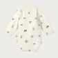White baby onesie with black animal prints on a white background