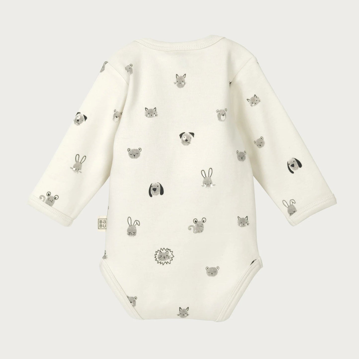 White baby onesie with black animal prints on a white background