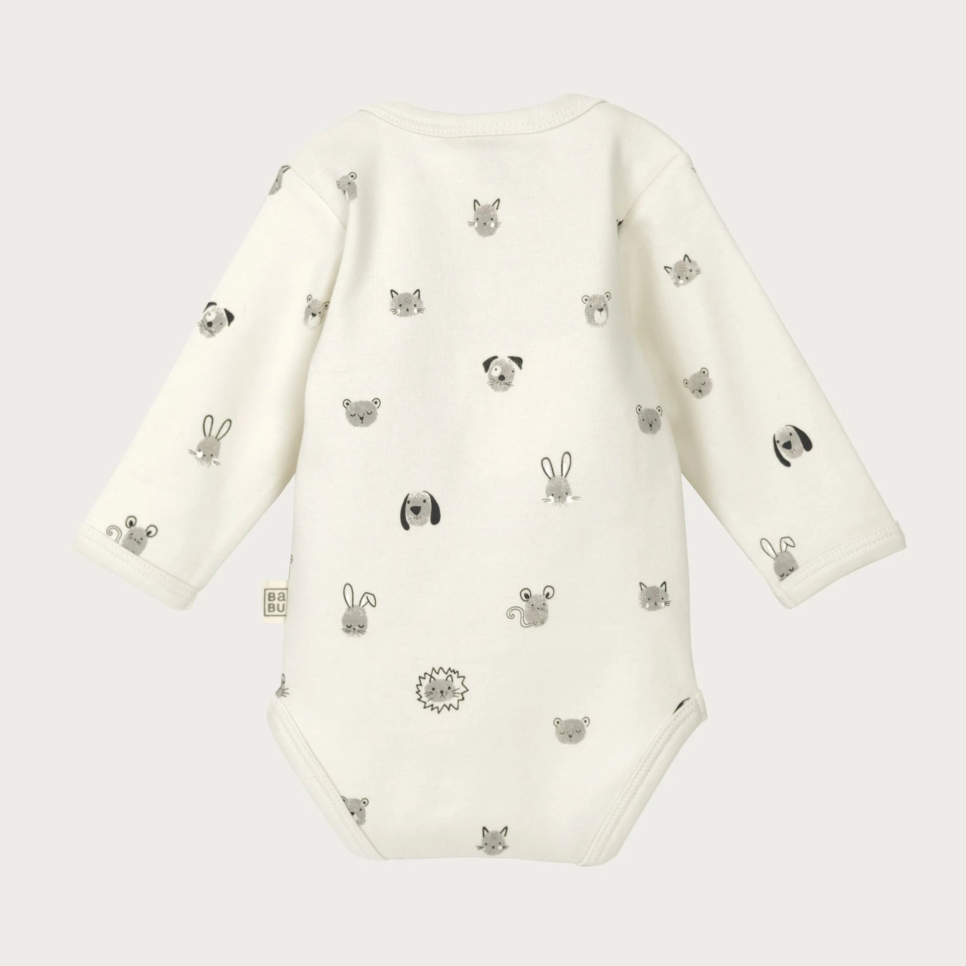 White baby onesie with black animal prints on a white background