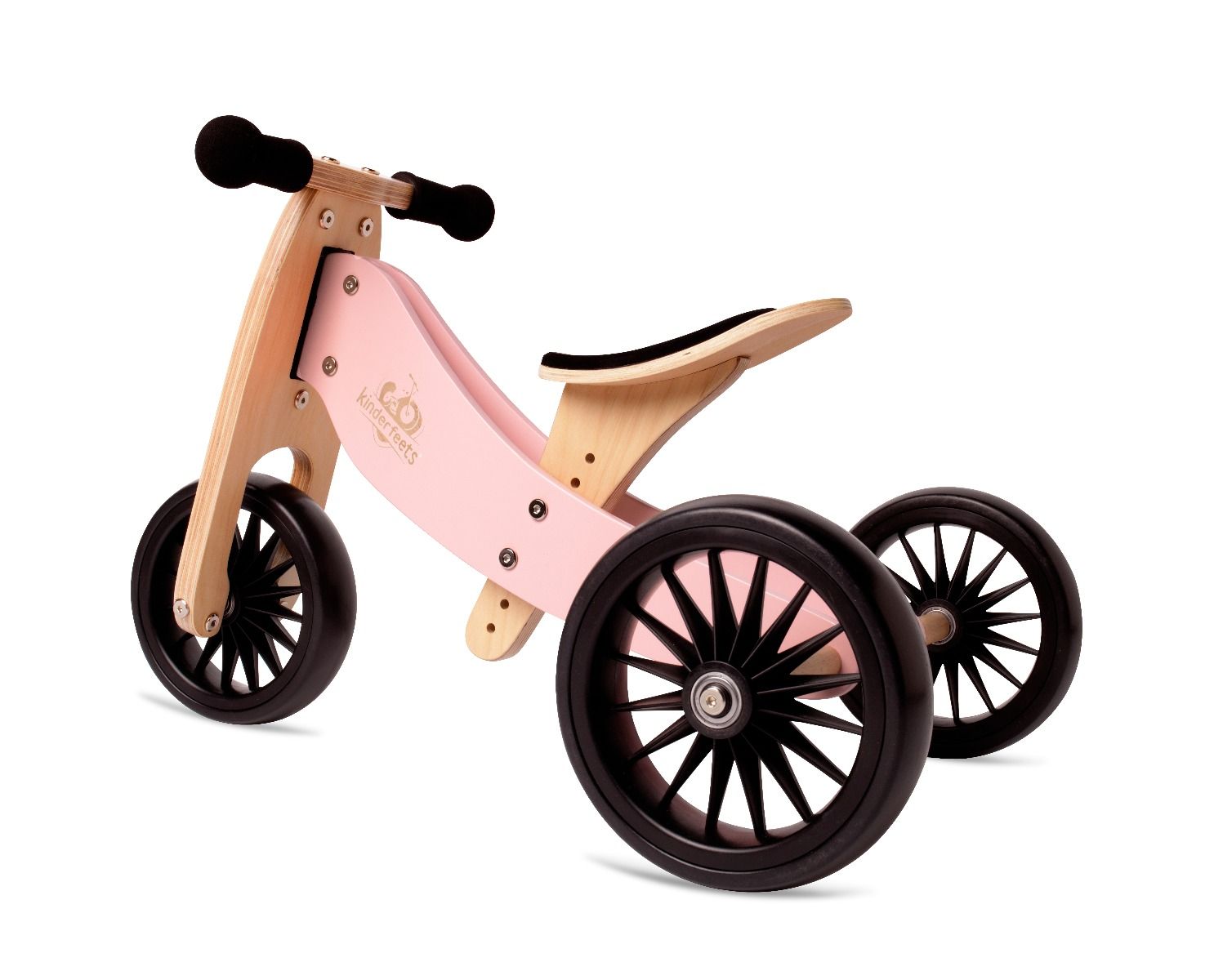 Pink and wooden balance bike with black wheels on a white background
