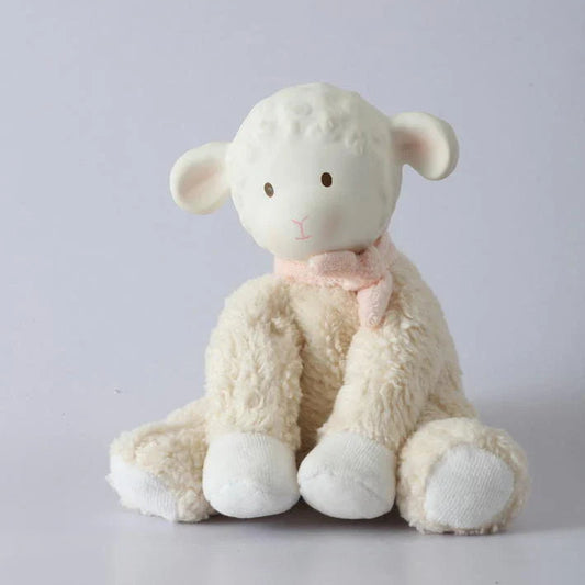 Stuffed sheep toy with a pink bow on a light gray background
