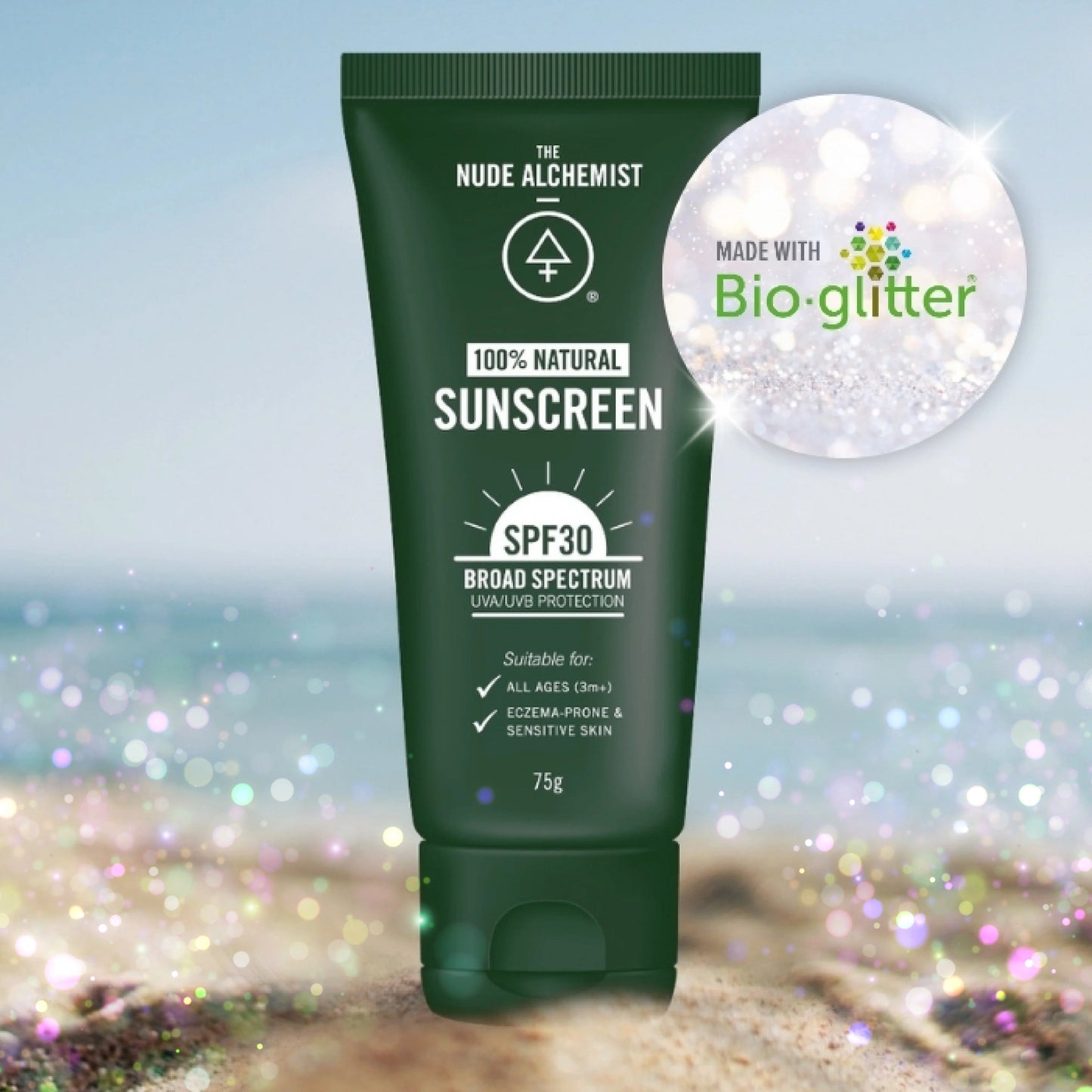 Green sunscreen tube with 'The Nude Alchemist' branding on a beach background