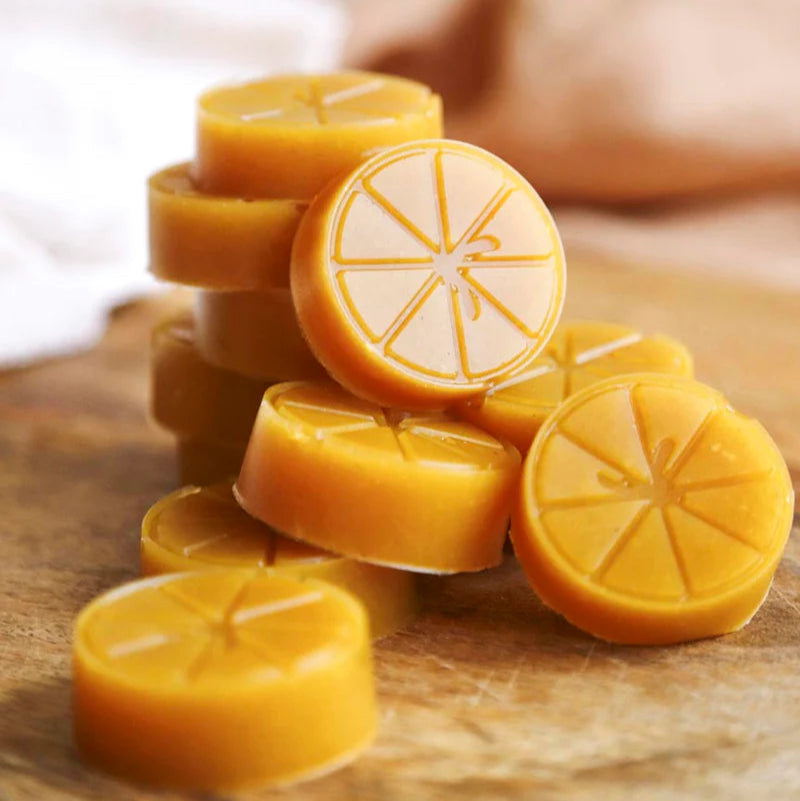 Stack of mango gutsy gummies on a wooden surface