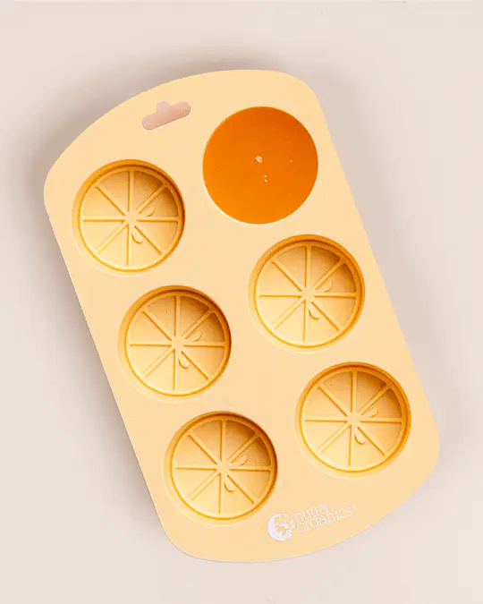 Silicone mould with orange shapes on a beige background