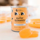 Can of Nutra Organics Gutsy Gummies with gummy bears on a blurred background