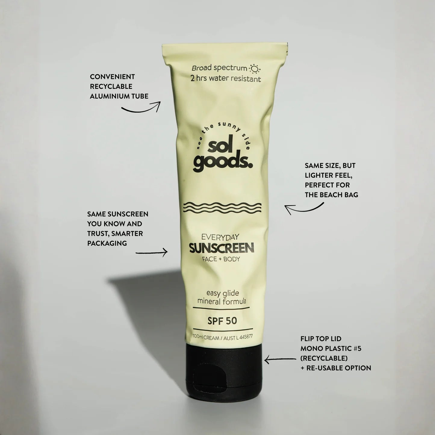 Sunscreen tube with branding and product details on a light gray background